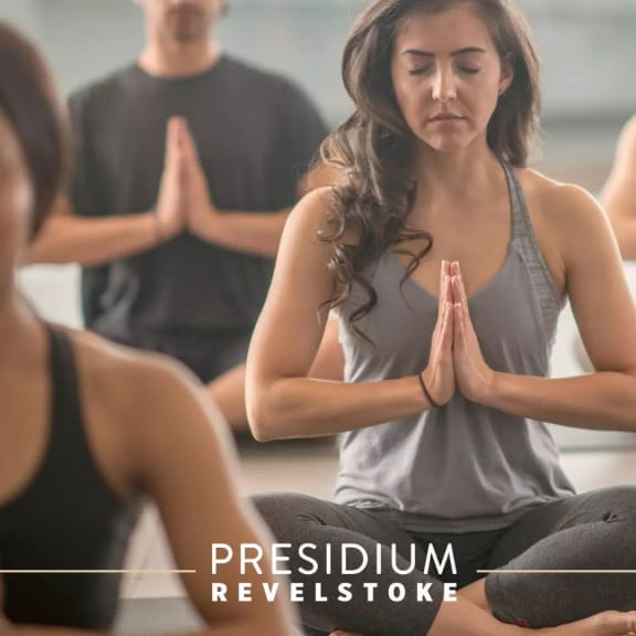 a group of people sitting in a yoga class at Presidium Revelstoke, Texas