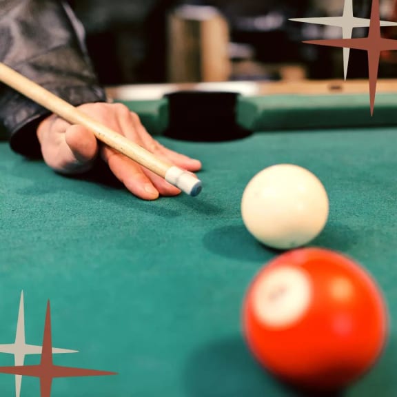 a man playing billiards with a cue on a pool table at Presidium Revelstoke, Fort Worth, TX, 76131