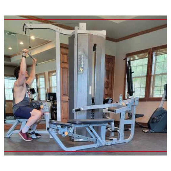 a man is doing a pull up on a gym machine  at Valor at Harlingen, Harlingen, TX