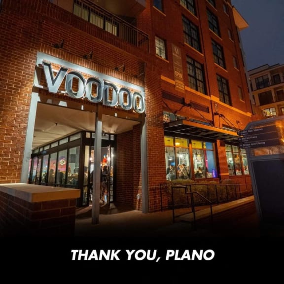 the facade of a store at night with a sign that reads thank you plasma