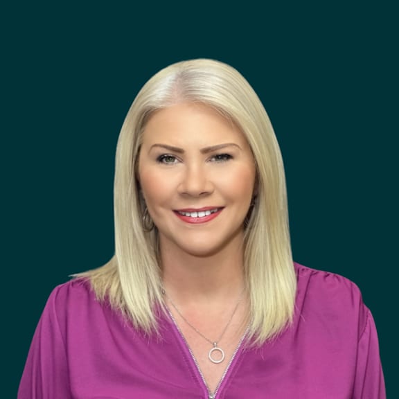 a woman in a pink jacket and a black shirt