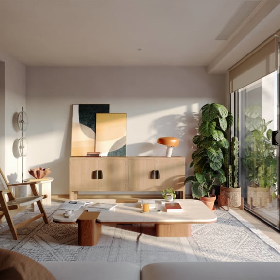 a living room with a coffee table and a plant