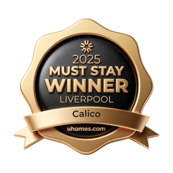 A gold badge stating "2025 Must Stay Winner Liverpool" and "Calico" with a ribbon.