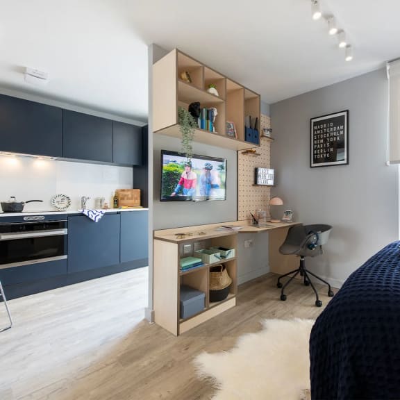 a room with a desk and a television in it