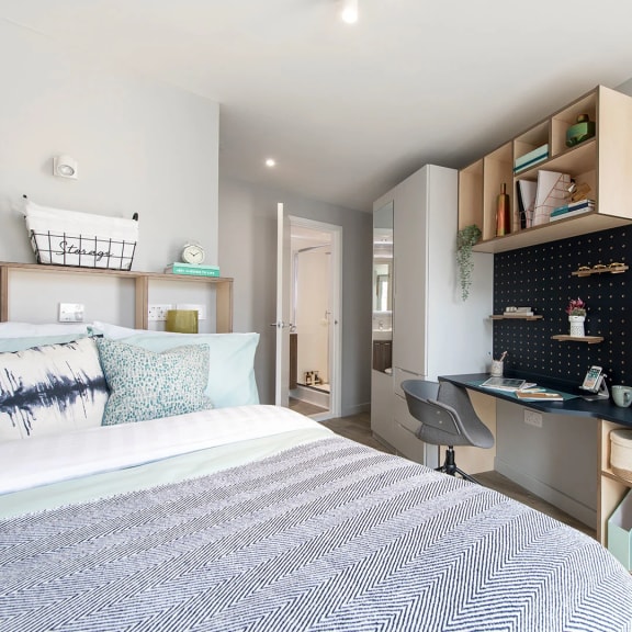 a bedroom with a bed and desk in a 555 waverly unit