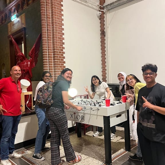 A group of people are gathered around a table playing a game.