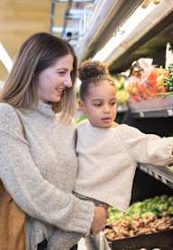 A woman and a child are shopping for produce at Clarkston Station Apartments, Clarkston, 30021