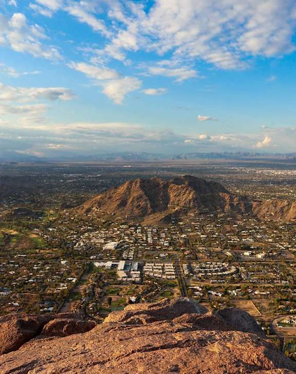 a view of the city from the top of a mountain