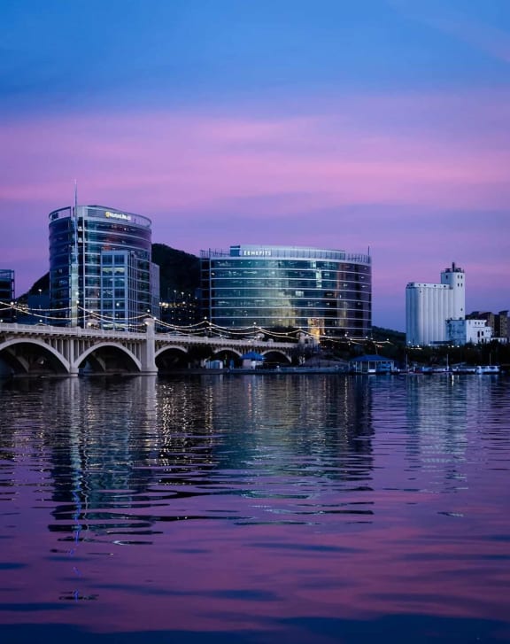 a city with a purple sky and a bridge over a body of water  at Sofia Apartments, Tempe, AZ, 85283