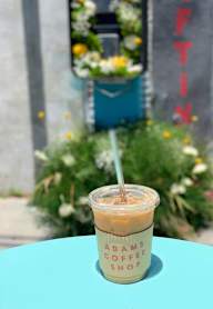 A cup of iced coffee from Adams Coffee Shop on a table.at 5135 W Adams, Los Angeles