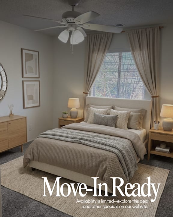 A bedroom advertisement for Muirfield Apartments showcasing a neatly made bed and a "Move-In Ready" sign.