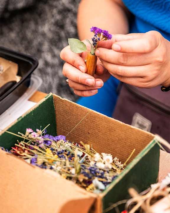 a person planting flowers in a box