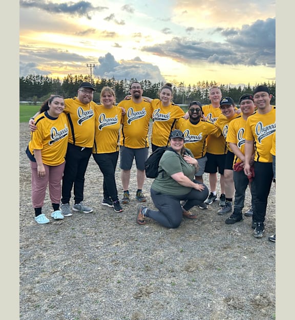 A group of people wearing yellow shirts with the word "Ontarians" on them are posing for a photo.