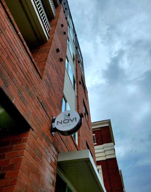 A brick building with a sign that says "NOV".