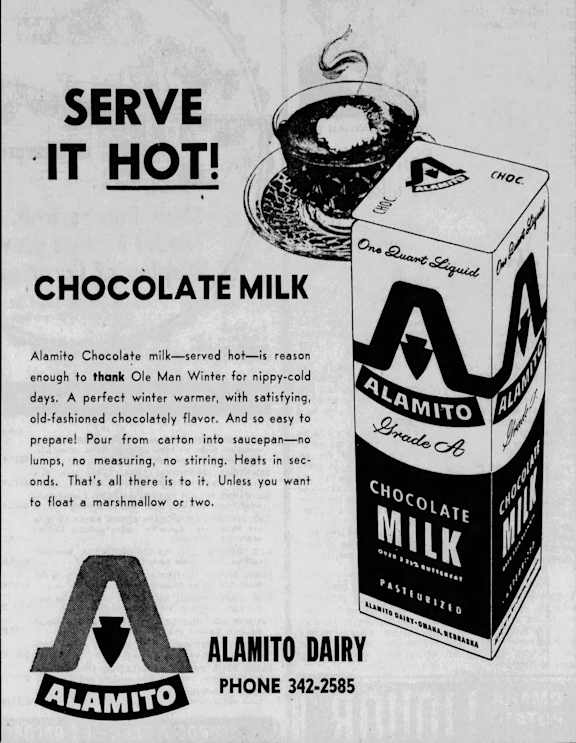 An advertisement for Alamito Chocolate Milk, which is served hot, is displayed.