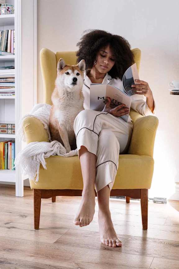a brown chair with a white and black blanket on it