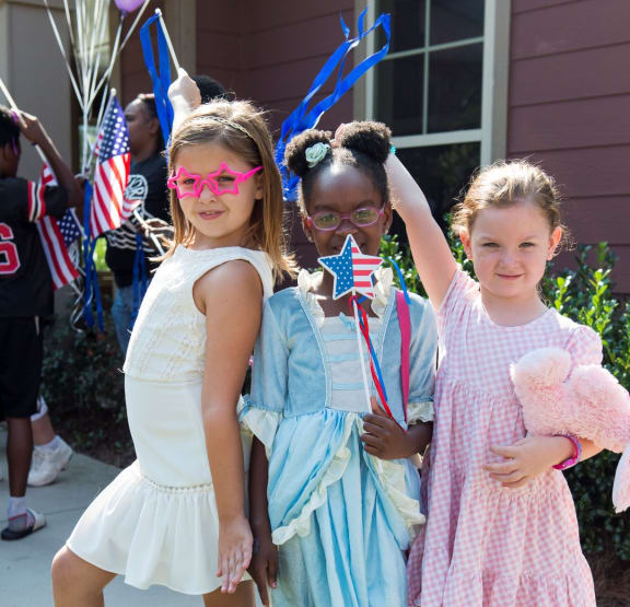 three girls dressed up for the 4th of july parade