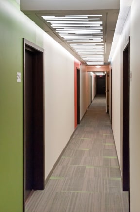 Bright Multicolored Hallway at 2800 Girard Apartments