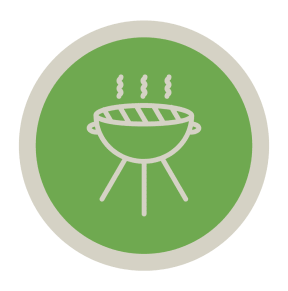 a green and white bbq grill on a black background