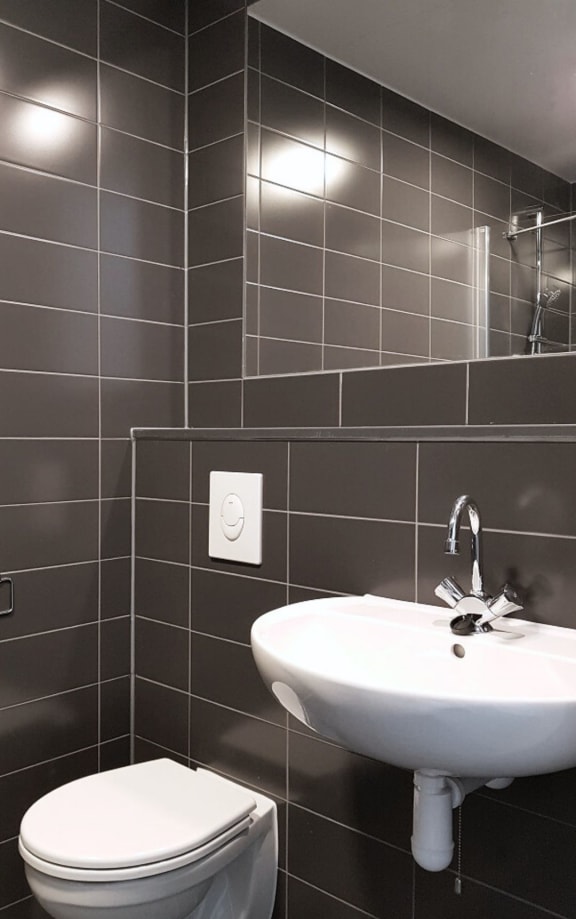 a white bathroom with a sink and a toilet