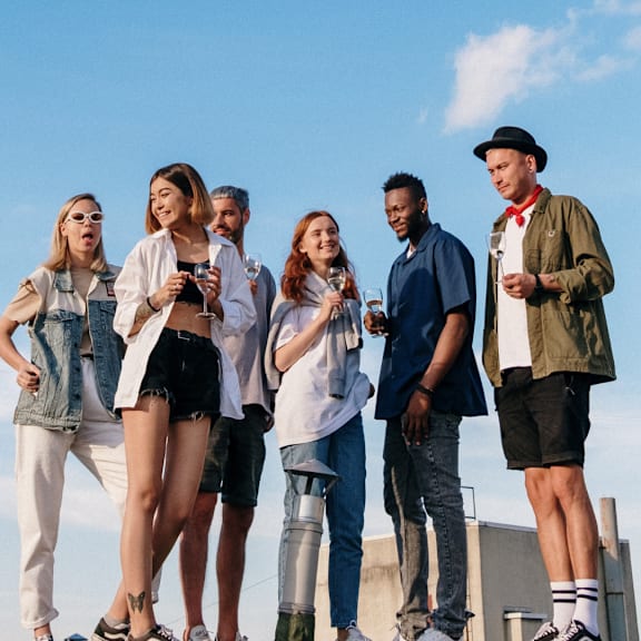 A group of people are standing on a rooftop.