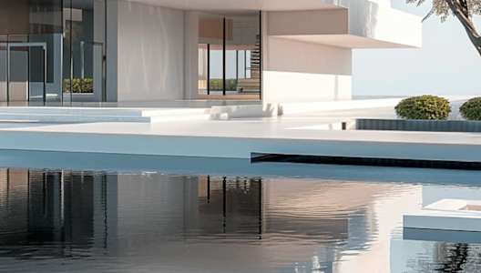 A modern house with a pool in front.