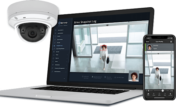 A security camera system is displayed on a laptop and a smartphone.