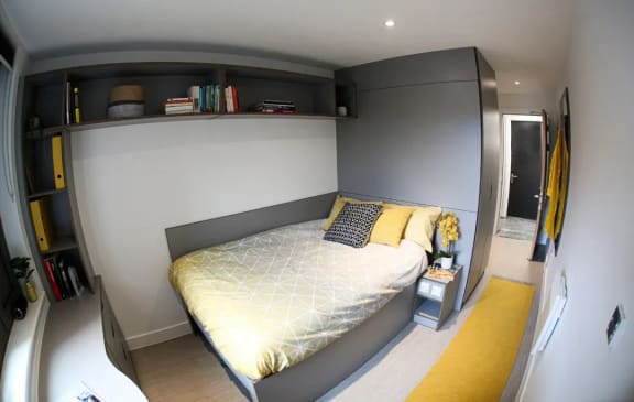a bedroom with a bed and a nightstand