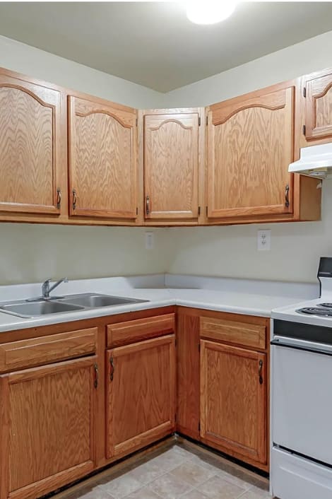 a kitchen with white appliances and wooden cabinets
