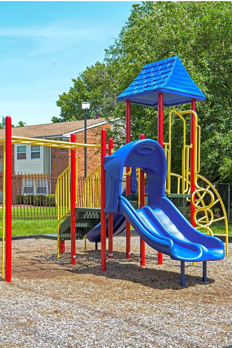 our apartments have a playground with a slide and a picnic table