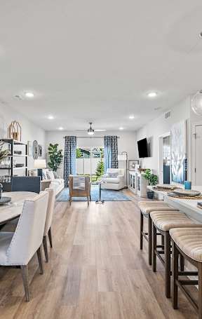 A modern kitchen and dining area with a large painting on the wall.