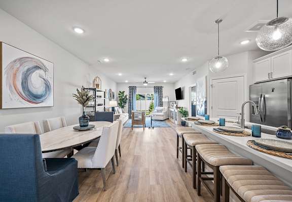 A cityscape with buildings and a body of water in the background.