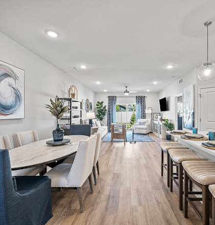 A modern kitchen and dining area with a large painting on the wall.