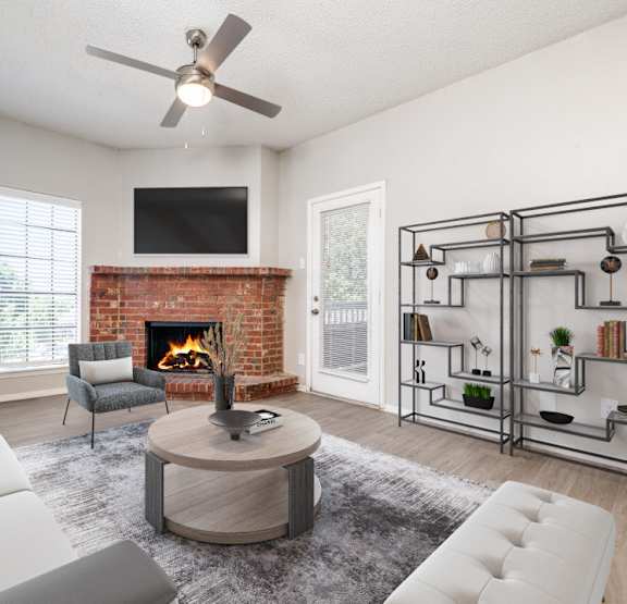 a living room with a ceiling fan and a large window at Hampton Gardens, Missouri, 63139