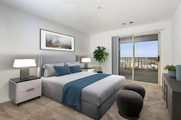 A bedroom with a large bed and a view of the city.