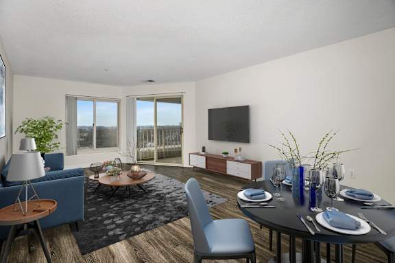 A modern dining room with a round table set for six.