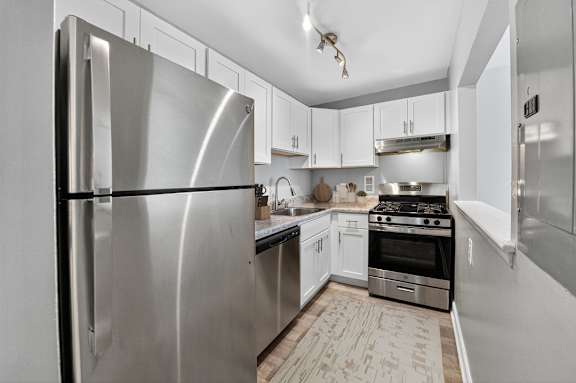 A modern kitchen with a stainless steel refrigerator.