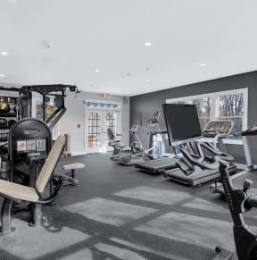 the home gym has weights and dumbbells in it