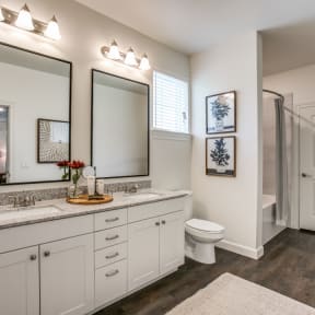 a bathroom with two mirrors and a toilet