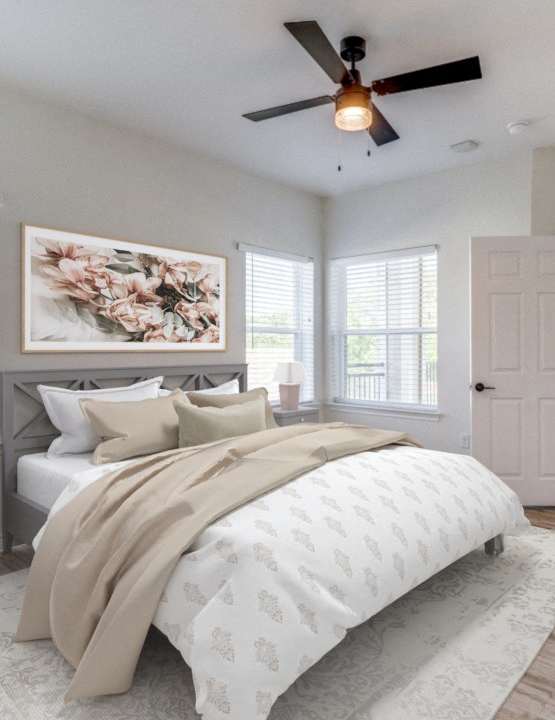 an empty bedroom with a bed and a ceiling fan