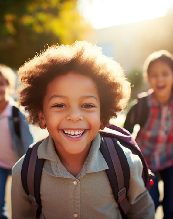 a group of young children walking down a sidewalk
