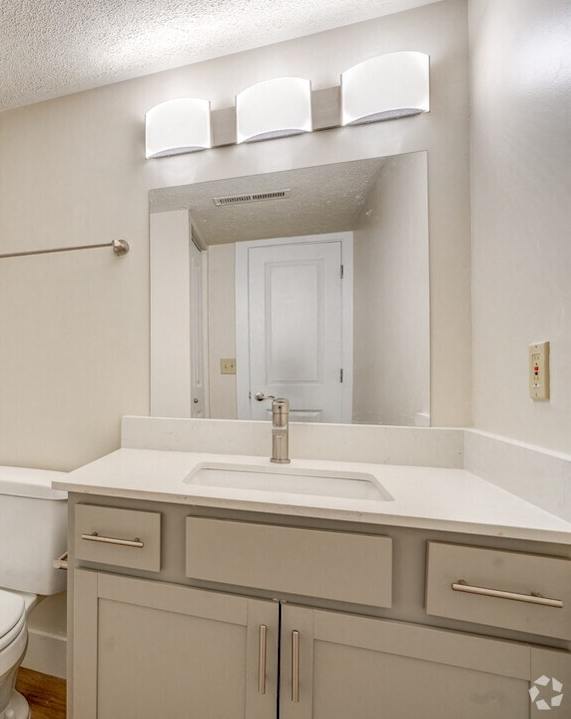 a bathroom with a sink toilet and a tub