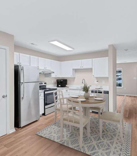 A kitchen with a table and chairs in the middle of the room.