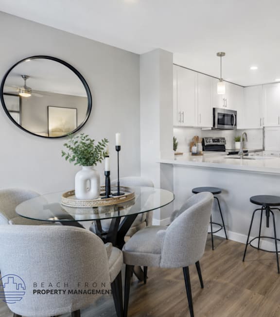 A well-lit, modern kitchen and living room with a dining area.