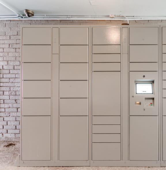 a row of lockers in a room with a brick wall