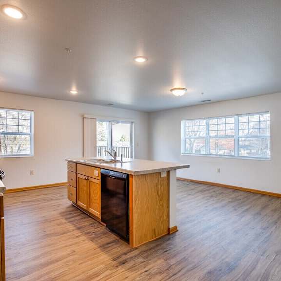 A kitchen with wooden cabinets and a large island.