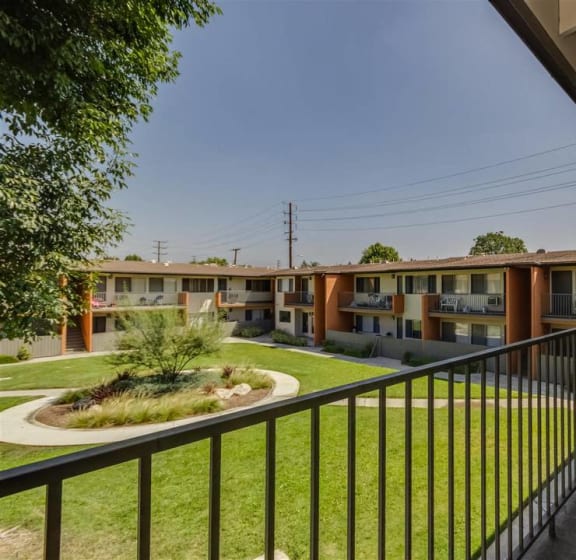 a patio with a table and chairs and a grill at Sunset Square, West Covina California