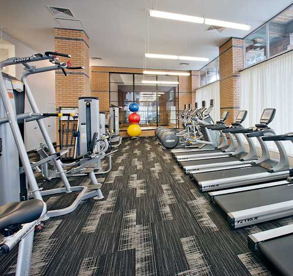 A gym with treadmills, exercise bikes, and other equipment.at 21 West, New York, 10006