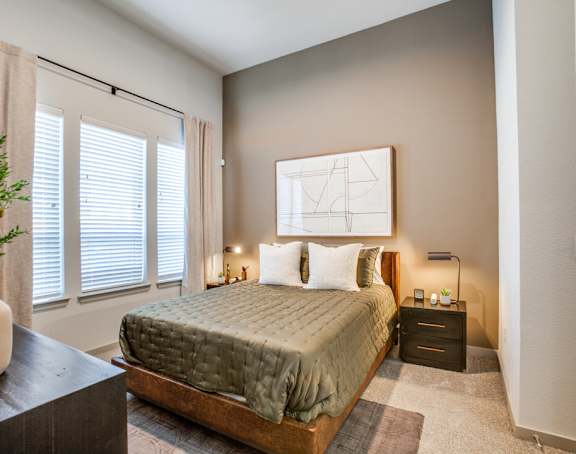 a bedroom with a bed and a large window