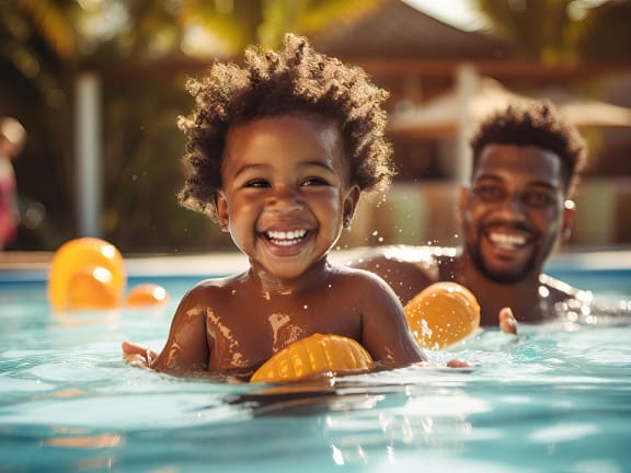 a man and a child swimming in a swimming pool